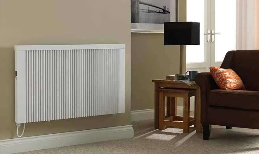 White electric radiator in a lounge beside a side table and sofa