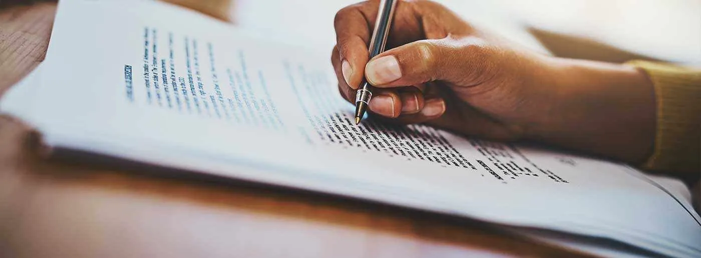Hand writing on a printed document with a pen
