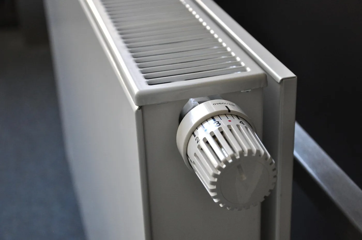 Close-up of a thermostatic valve on a white central heating radiator