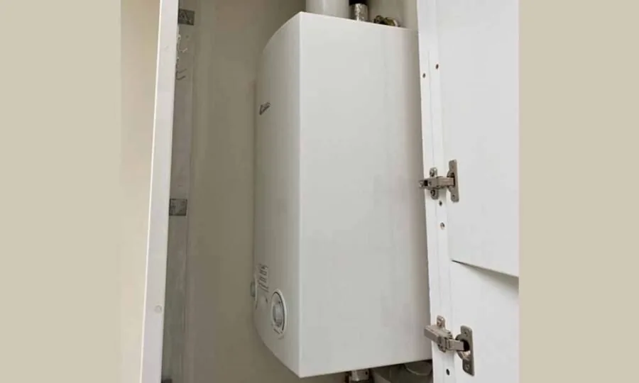 Old gas boiler removed from a utility room during conversion to electric heating