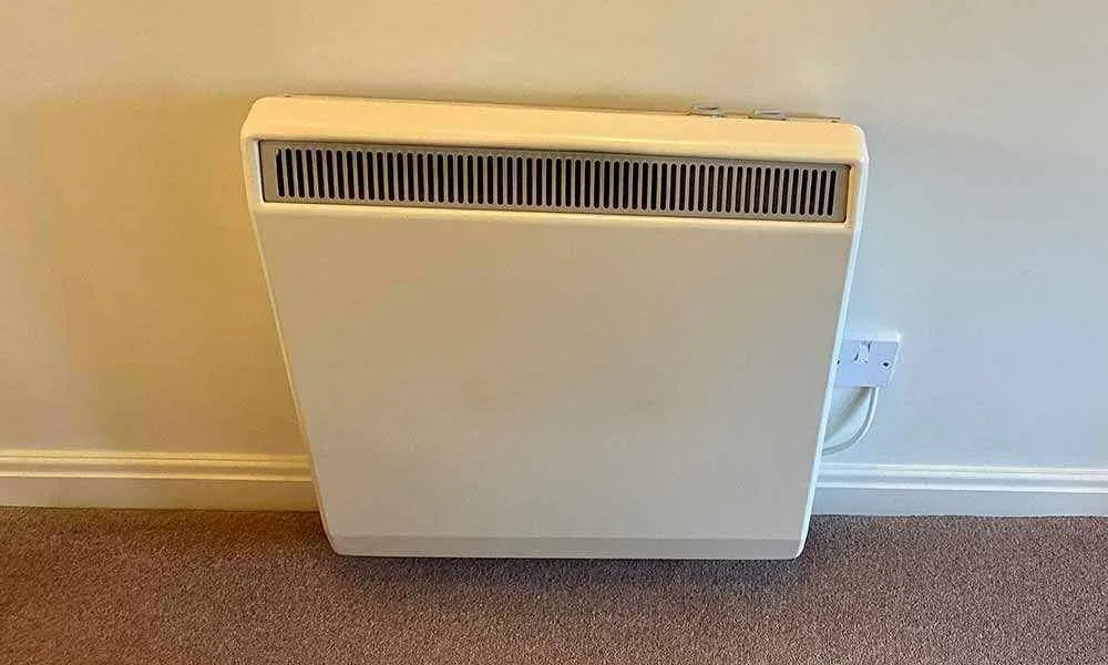 Old night storage heater being removed and replaced with a modern electric radiator